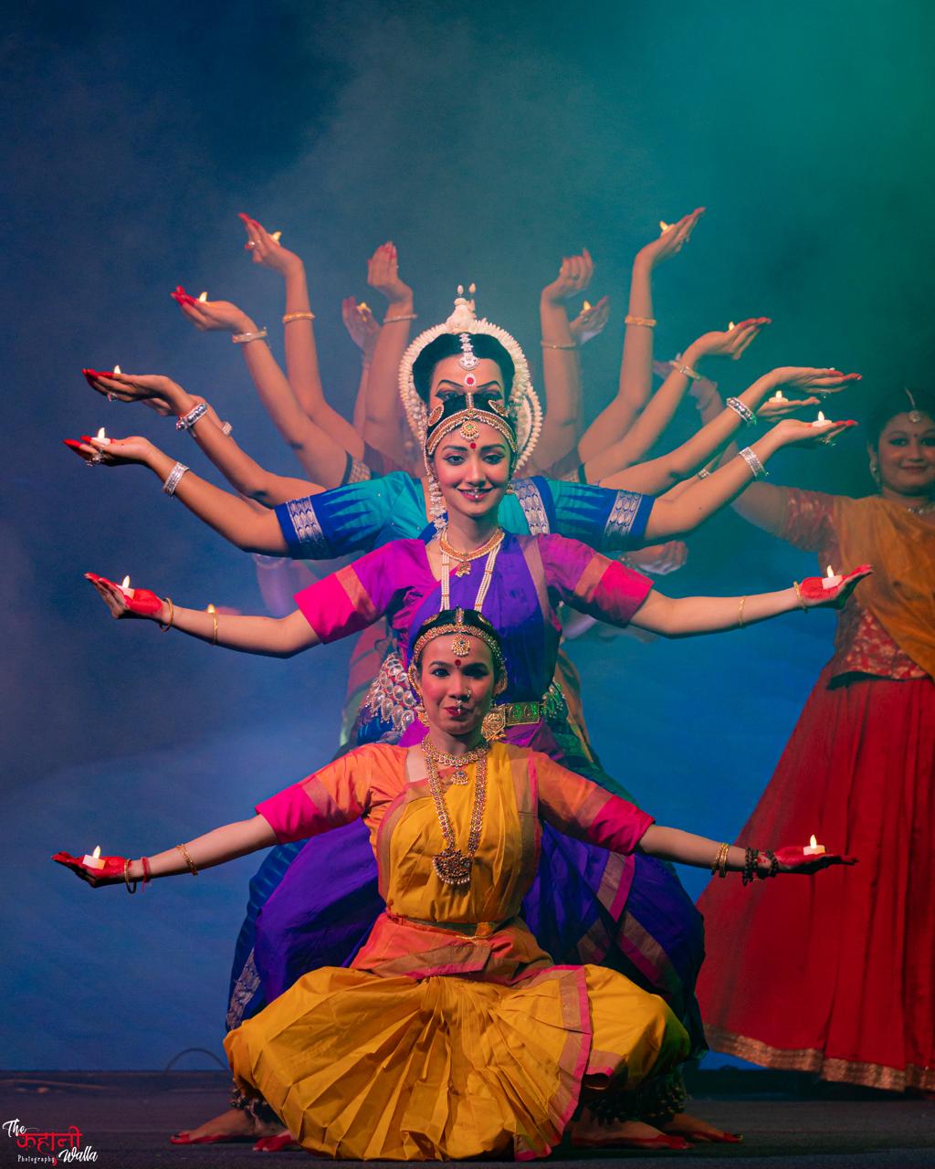 Trikāyaa multi-armed devotional formation with lamps